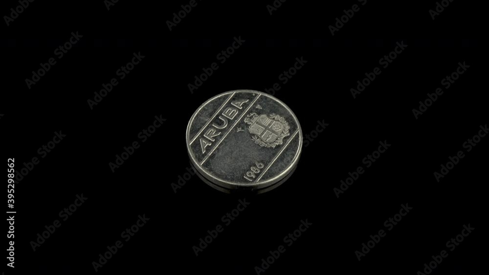 Small coin of Aruba from the year 1986. Back of 25 cents coin with Aruba and its coat of arms embossed on it Small coin of Aruba from the year 1986. Back of 25 cents coin with Aruba and its coat of arms embossed on it
