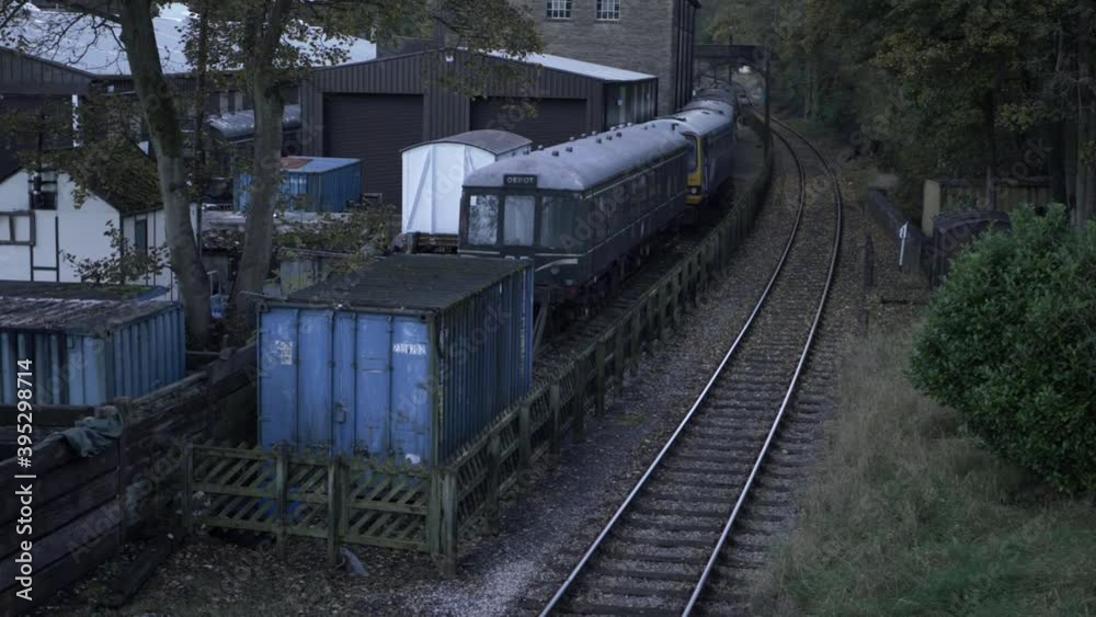 Empty single train track with parked carriages view from bridge wide tilting shot Empty single train track with parked carriages view from bridge wide tilting shot