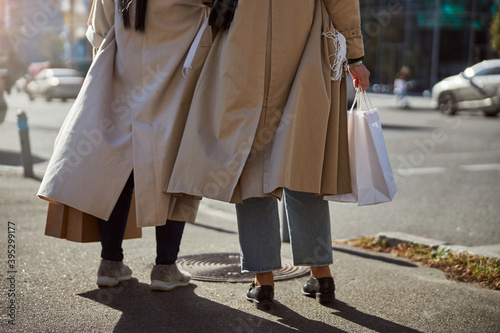 Two elegant women standing on the street