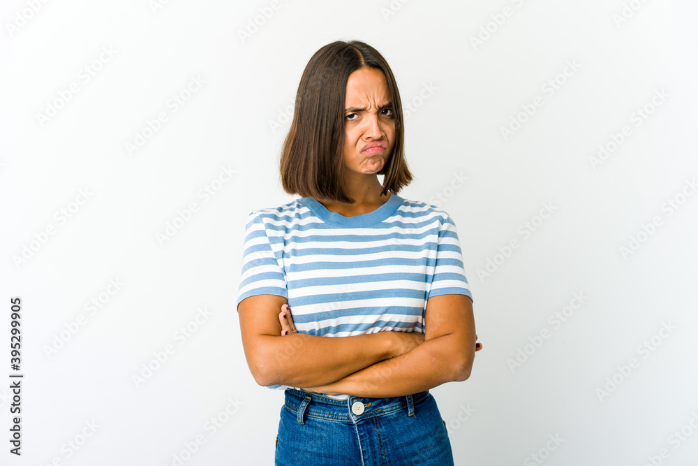 Young mixed race woman frowning face in displeasure, keeps arms folded. Young mixed race woman frowning face in displeasure, keeps arms folded.