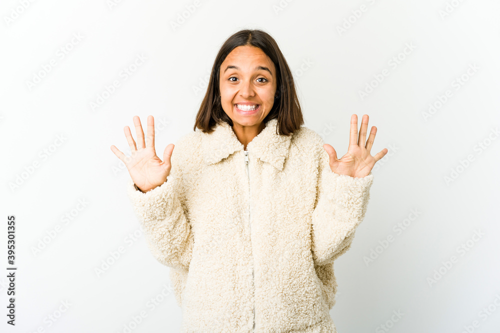 Young mixed race woman showing number ten with hands. Young mixed race woman showing number ten with hands.