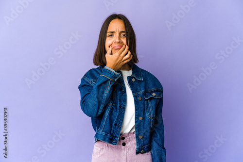 Young mixed race woman doubting between two options.