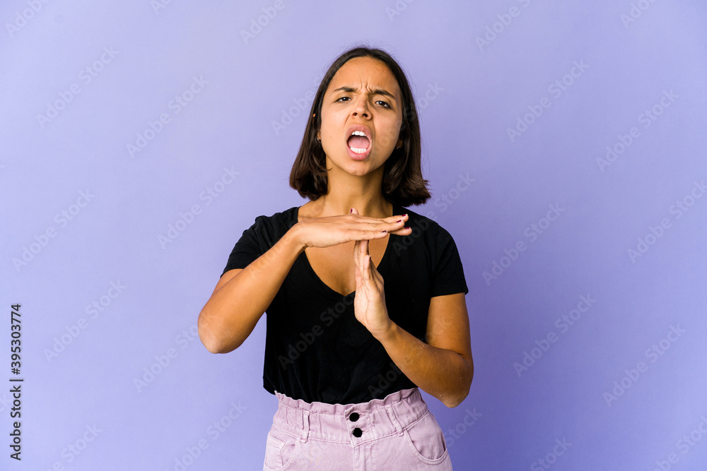 Young mixed race woman showing a timeout gesture. Young mixed race woman showing a timeout gesture.
