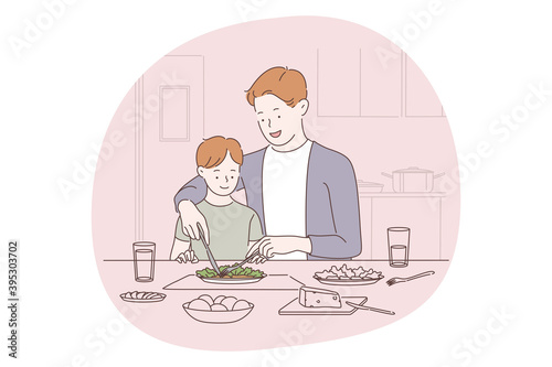 Family care, fatherhood, fathers day concept. Man father daddy coach parent helping in cutting and eating healthy dish during dinner with small son in kitchen at home. Fathers day, love, care, dad 