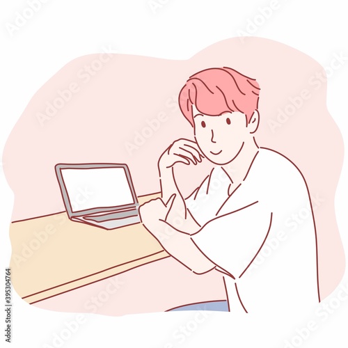 Man sitting in front of laptop computer.