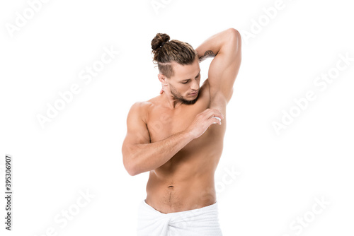  shirtless man using deodorant isolated on white © LIGHTFIELD STUDIOS