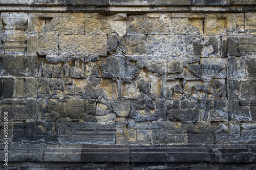 Bas-relief statue at Borobudur, a 9th-century Mahayana Buddhist temple in Central Java photo