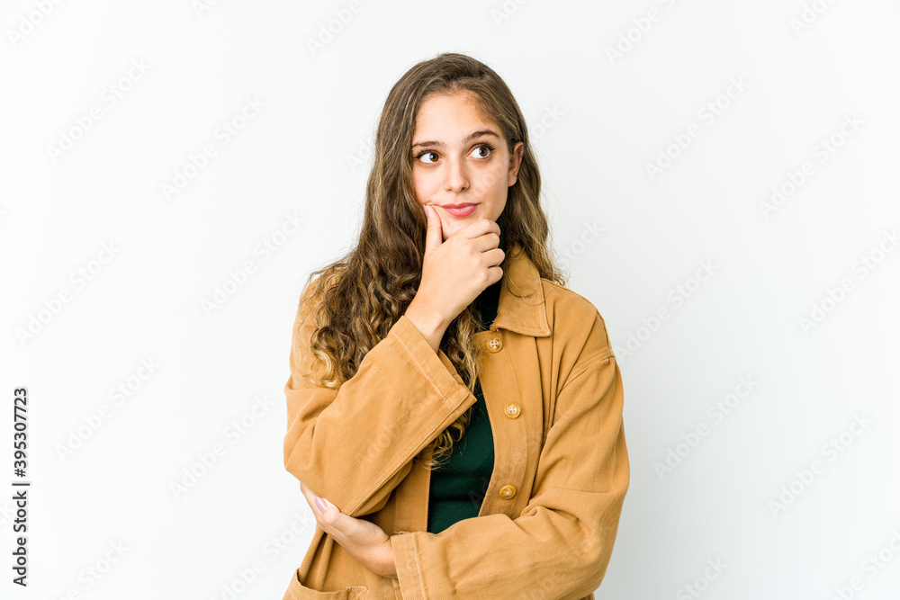 Young caucasian woman looking sideways with doubtful and skeptical expression. Young caucasian woman looking sideways with doubtful and skeptical expression.