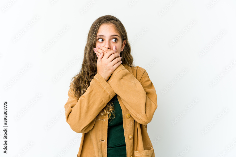 Young caucasian woman thoughtful looking to a copy space covering mouth with hand. Young caucasian woman thoughtful looking to a copy space covering mouth with hand.