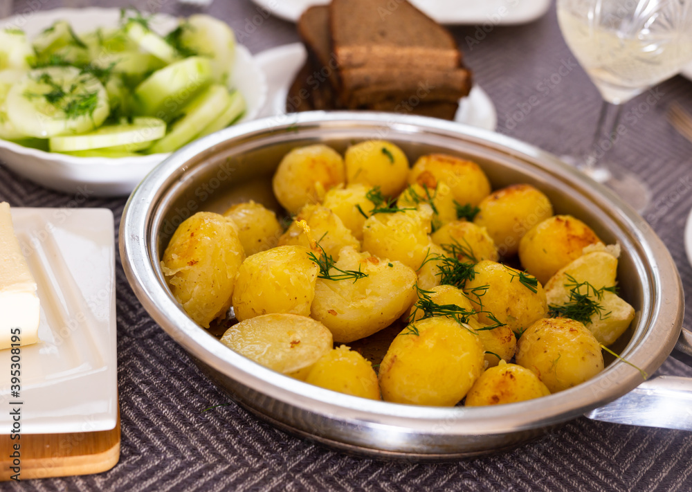 toasted young potatoes with dill in metal skillet toasted young potatoes with dill in metal skillet