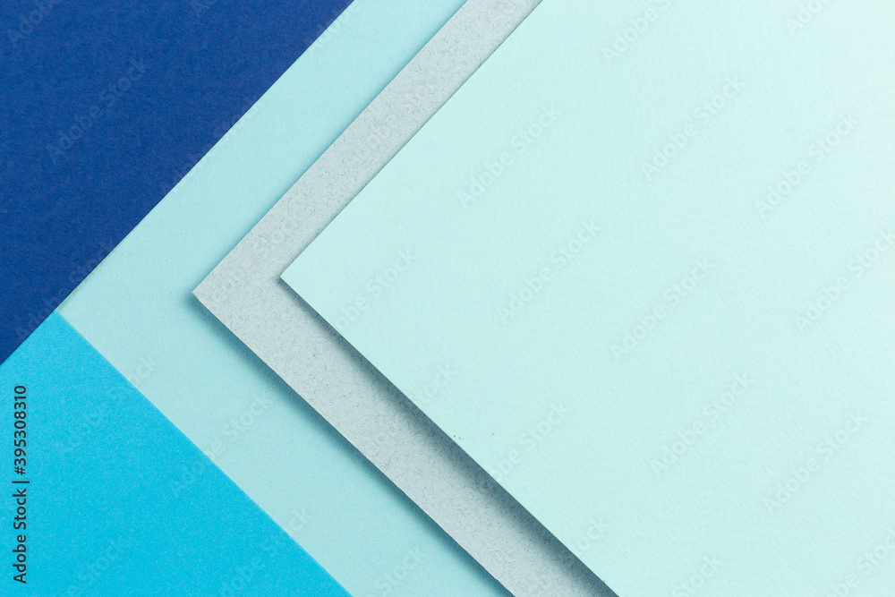Material design blue background. Craft paper sheets are folded in different ways. A photo. Material design blue background. Craft paper sheets are folded in different ways. A photo.