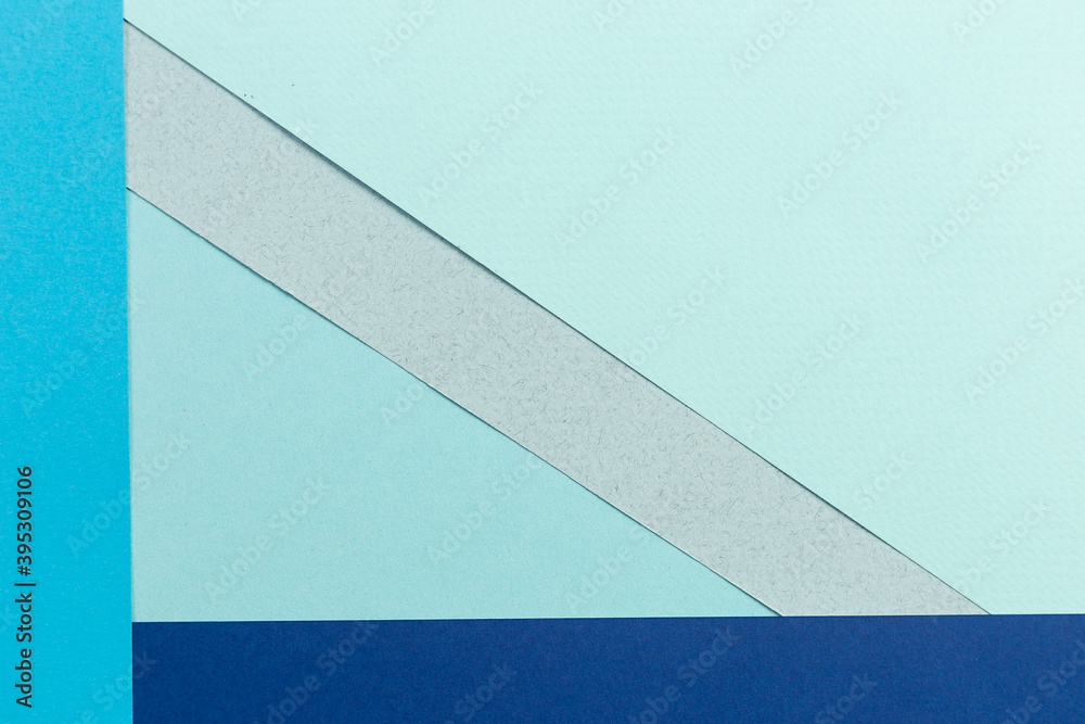 Material design blue background. Craft paper sheets are folded in different ways. A photo. Material design blue background. Craft paper sheets are folded in different ways. A photo.