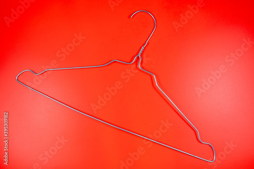 Metal clothes hanger on a red background