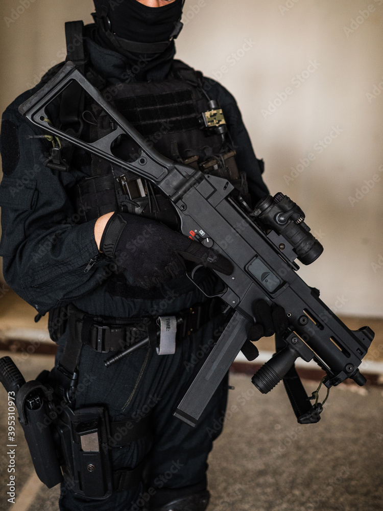 Woman as a police member of swat unit wearing a black jumpsuit and ...