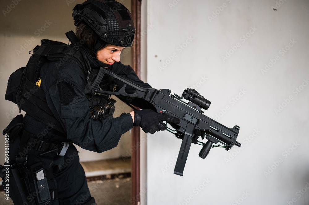 Man reenacting special unit of Croatian military police. Wearing green jumpsuit with black add-ons and assault rifle G36.
