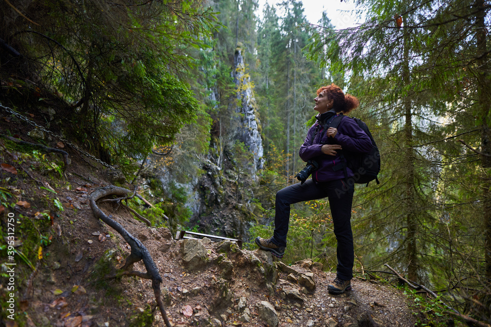 Tourist lady with camera hiking Tourist lady with camera hiking