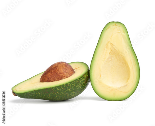 half ripe green avocado with a brown stone isolated on a white background