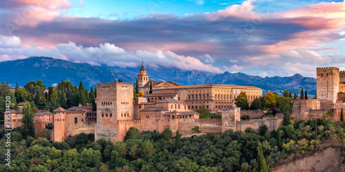 Palace and fortress complex Alhambra with Comares Tower, Palacios Nazaries and Palace of Charles V during sunset in Granada, Andalusia, Spain photo