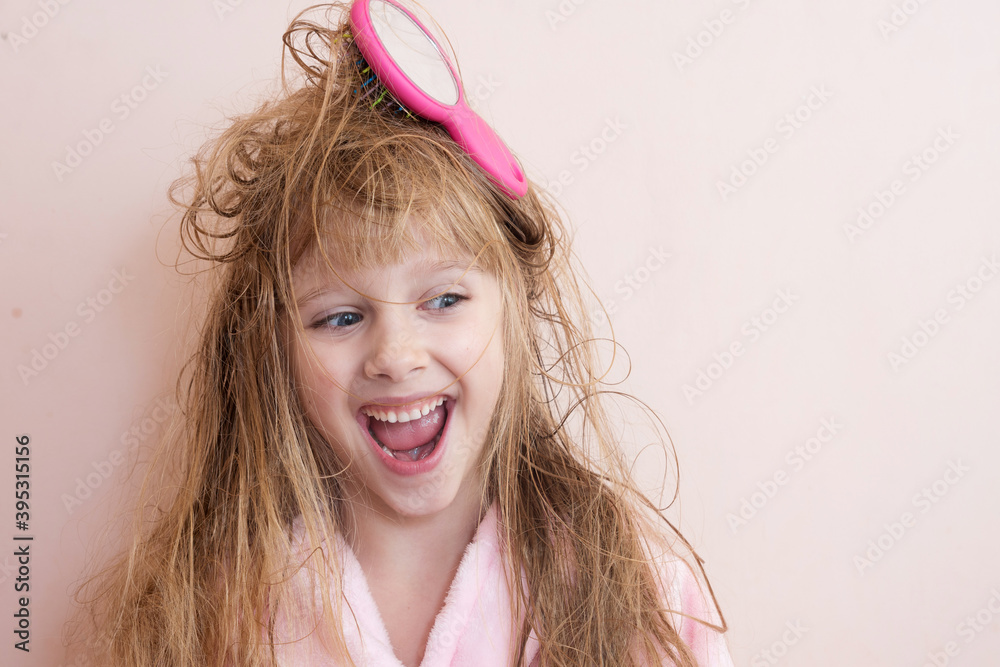 little girl brushes her tangled hair after a shower Stock Photo Adobe Stock