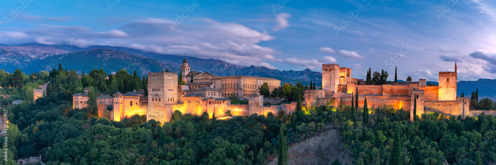 Palace and fortress complex Alhambra with Comares Tower, Palacios Nazaries and Palace of Charles V during sunset in Granada, Andalusia, Spain