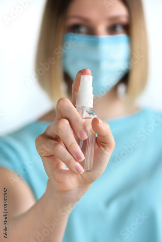 Young woman using spray disinfection product  health prevention contaminating with Corona virus