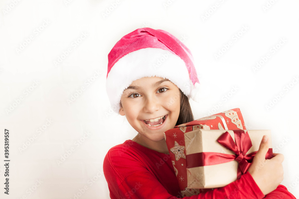 Happy smiling child girl Santa with Christmas boxes on white background Happy smiling child girl Santa with Christmas boxes on white background