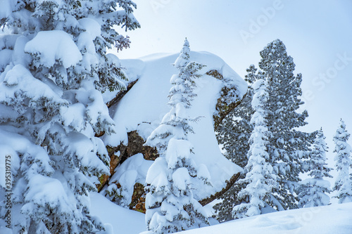 Sheregesh ski resort in Russia, located in Mountain Shoriya, Siberia. Winter landscape, trees in snow, clouds and big beautiful stone block photo