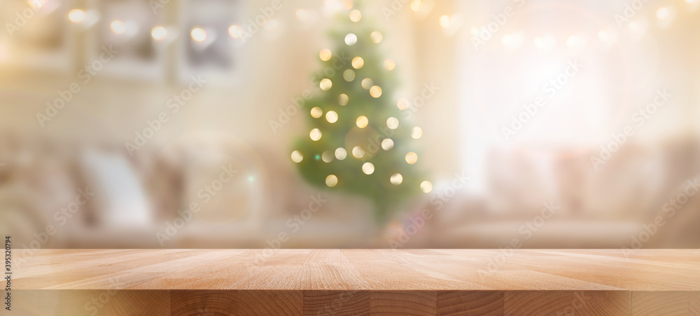A wood table, tabletop product display with a festive Christmas background of Christmas tree and fairy lights.
