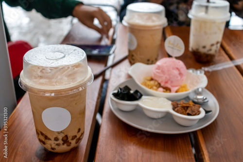 Pearl milk tea with ice cream on a wooden table