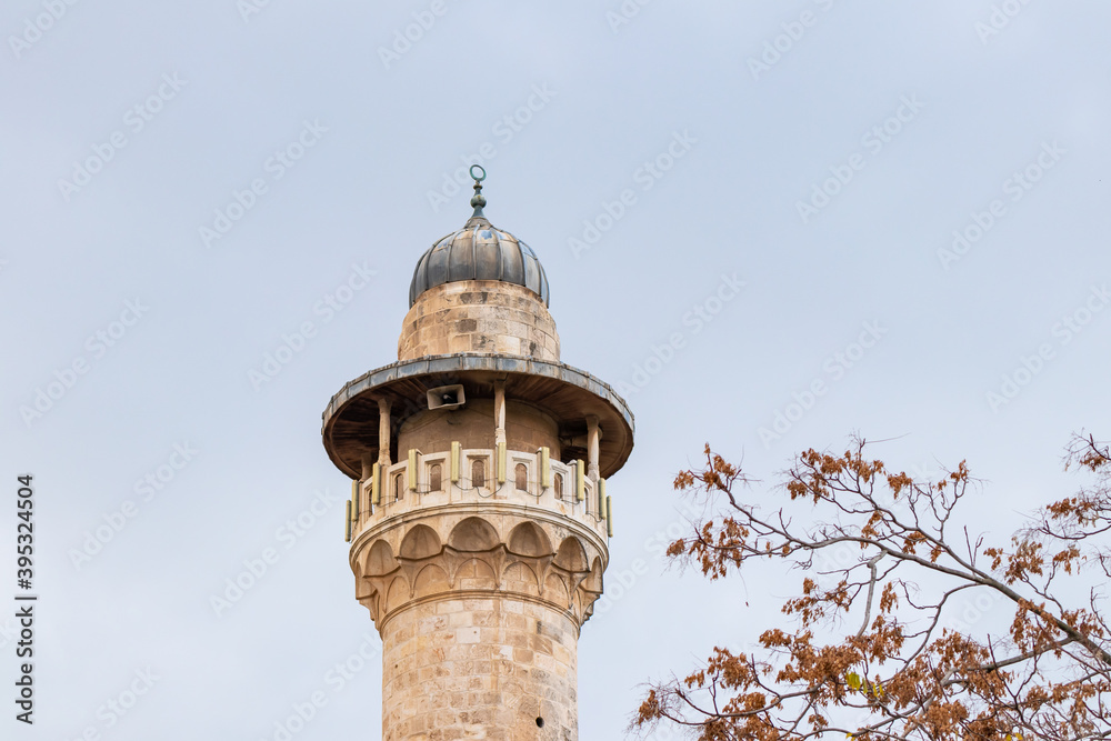 The top  of the minaret of the Sheikh Reihan Mosque towers over the walls of the Temple Mount in the old city of Jerusalem, in Israel