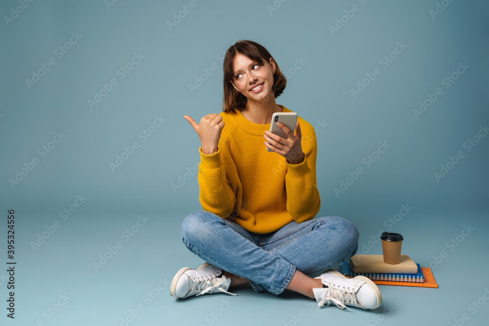 Smiling student girl using mobile phone Smiling student girl using mobile phone