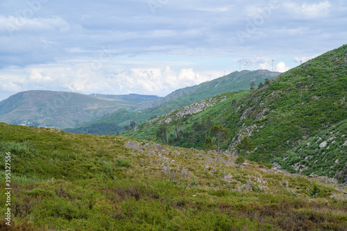 Freita mountain range highland. Rocky landscape with clouds. Hills with yellow and green vegetation.