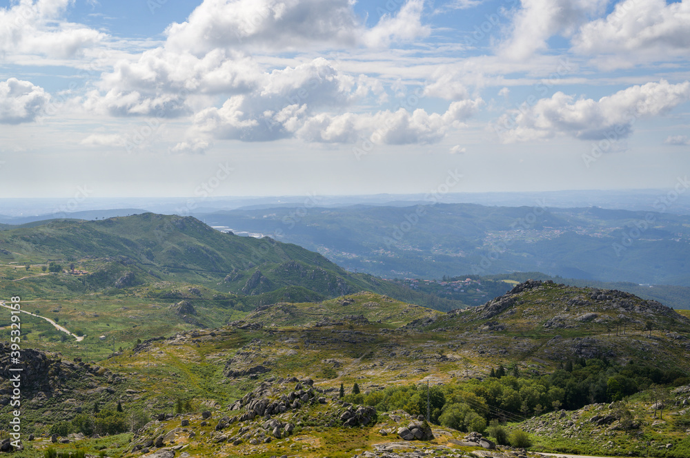 Freita mountain range highland. Rocky landscape with clouds. Hills with yellow and green vegetation.