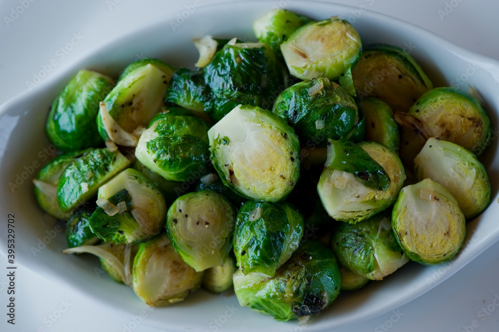 Brussels sprouts shaved and served with crispy bacon and seasoned with olive oil and seasoned with salt and pepper and fresh herbs. Classic American Restaurant appetizer favorite. 
