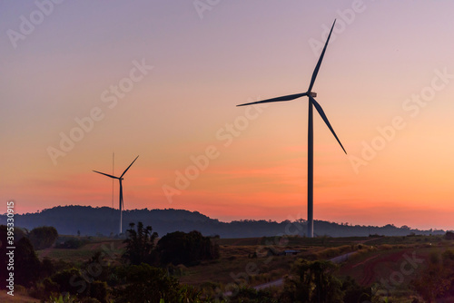 wind turbines park for make the electric power from wind in sunset time