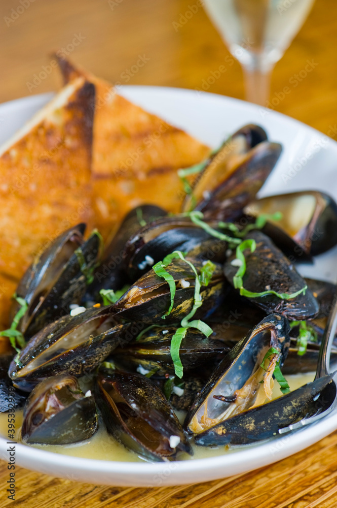 Mussels. Steamed mussels simmered with butter, garlic, shallots, red wine, tarragon, salt and pepper and served with toasted baguettes. Classic French bistro appetizer. Mussels. Steamed mussels simmered with butter, garlic, shallots, red wine, tarragon, salt and pepper and served with toasted baguettes. Classic French bistro appetizer.