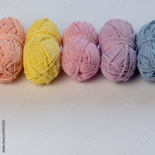 yellow and pink balls of wool