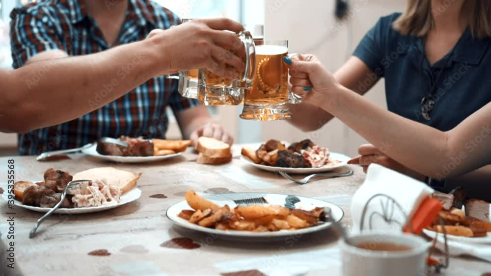 friends raise their glasses of beer friends raise their glasses of beer