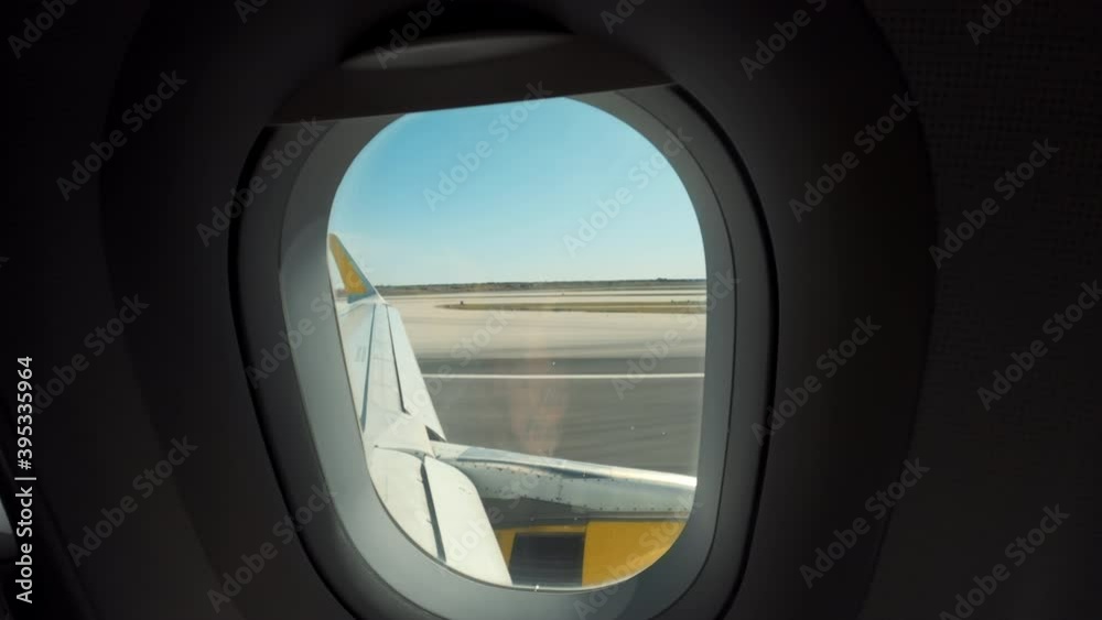 View from airplane window on wing when plane takes off from airport landing strip. Concept travel alone during travelling restrictions, cancelled or delayed flight View from airplane window on wing when plane takes off from airport landing strip. Concept travel alone during travelling restrictions, cancelled or delayed flight