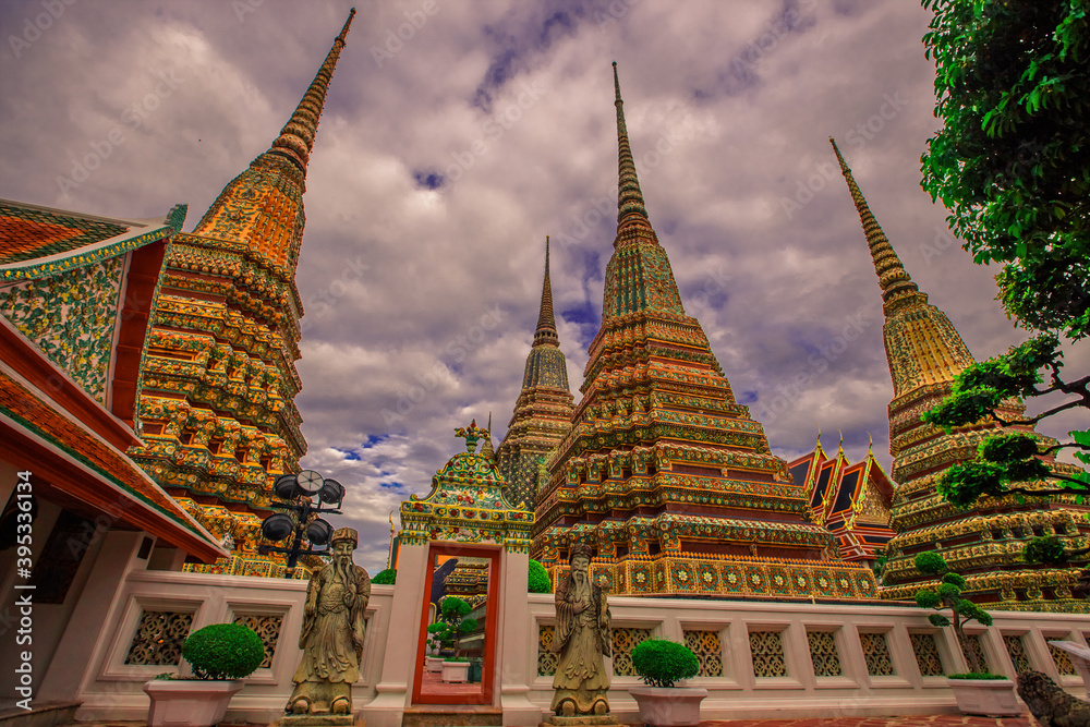 Fototapeta premium background of important religious attractions in Bangkok (Wat Phra Chetuphon (Wat Pho - reclining Buddha), a large pagoda and beautiful sculptural art give future generations to explore its history
