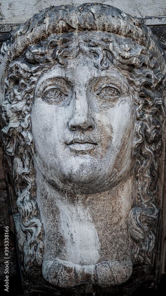 Ancient aged sculpture of beautiful Venetian Renaissance Era woman in Venice, Italy