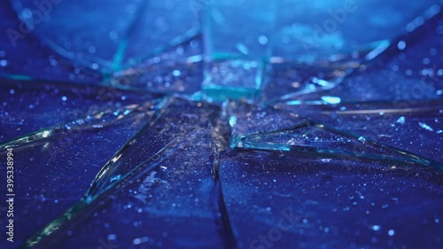 Chunks of broken glass shudder as they hit the table