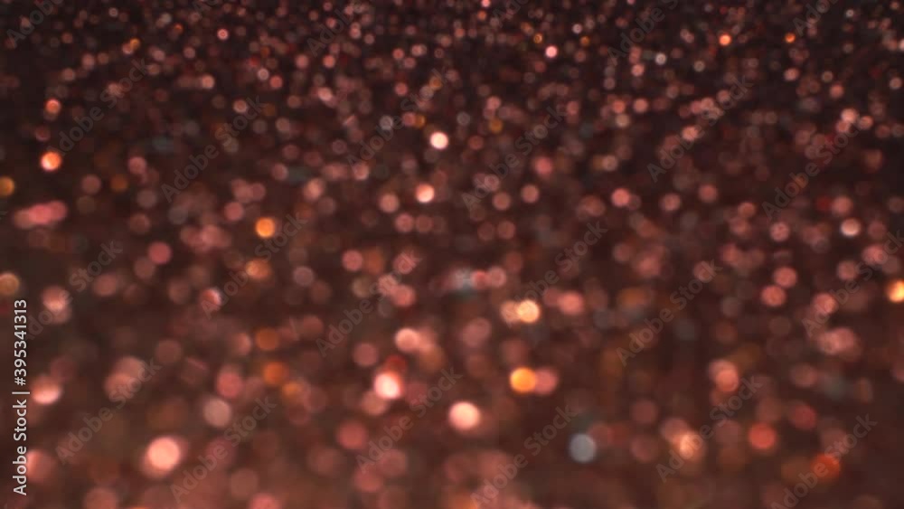 Copper bokeh holiday background for Christmas new year party. Magic shiny metallic texture, glitter and lights
