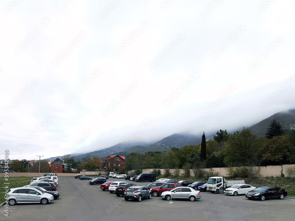 cars are parked on the side of a city street in a residential area near the mountains