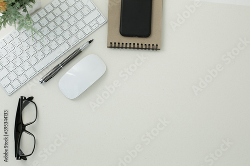 Keyboard mouse glasses pen notepad phone on white background
