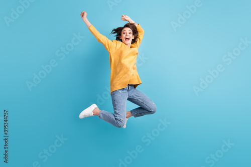 Full length body photo of cheerful happy girl with short hairstyle jumping high hands over head isolated on vivid blue color background