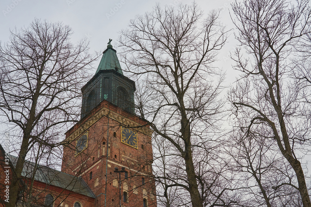 A clocktower of Turku Cathedral behind the trees. A clocktower of Turku Cathedral behind the trees.