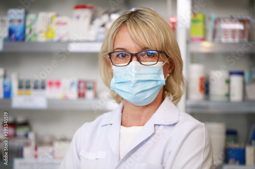 Close up portrait femal Phamacist or doctor wearing facemask in Pharmacy ship