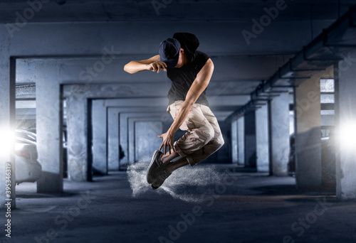 Young man break dancing on parking spaces