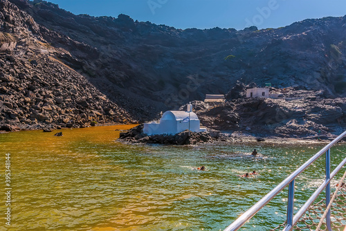 A view towards the thermal springs on the volcanic island of Palea Kameni, Santorini in summertime photo